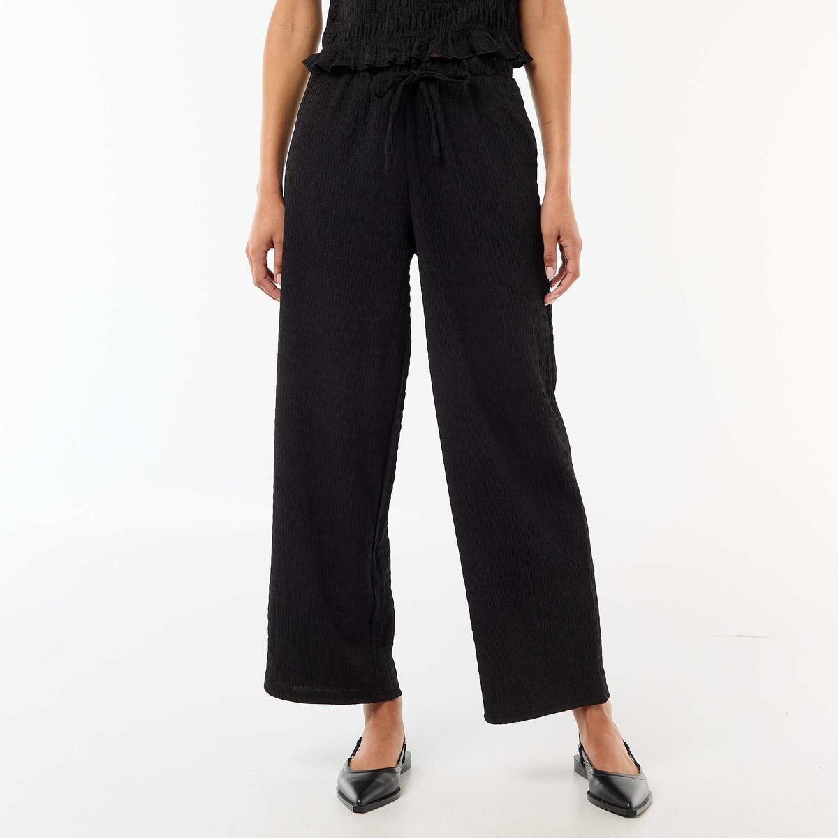Pantalon large en maille smockée NOIR